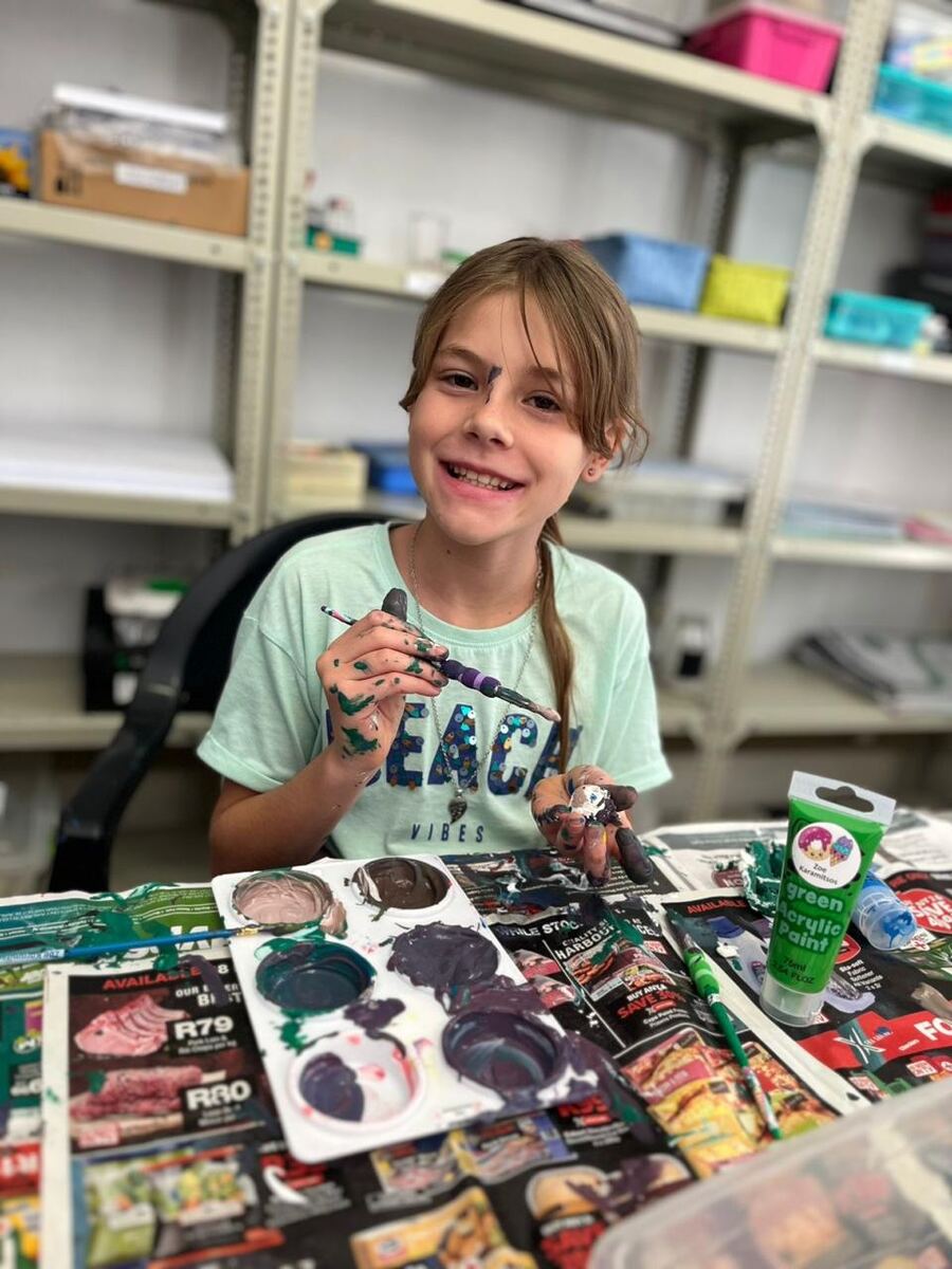 A learner painting during an art lesson