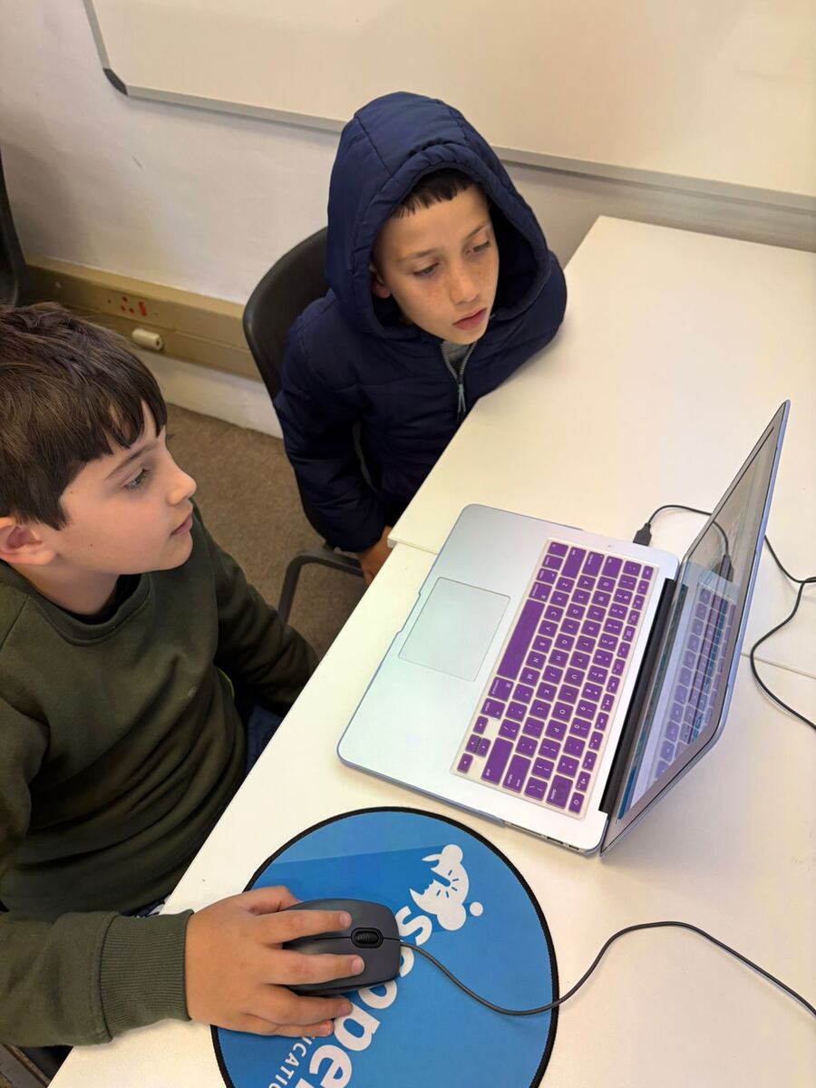 Learners working together on a laptop